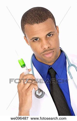 African American doctor holding a syringe View Large Photo Image Stock Photo - African American doctor holding a syringe. Fotosearch