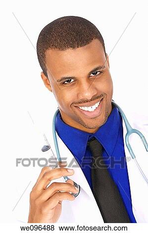 African American doctor holding a syringe View Large Photo Image Stock Photo - African American doctor holding a syringe. Fotosearch