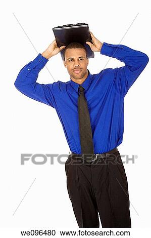 African American male businessman holding a laptop computer View Large Photo Image Stock Image - African American male businessman holding a laptop computer. Fotosearch
