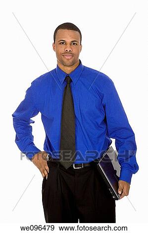 African American male businessman holding a laptop computer View Large Photo Image Stock Photo - African American male businessman holding a laptop computer. Fotosearch