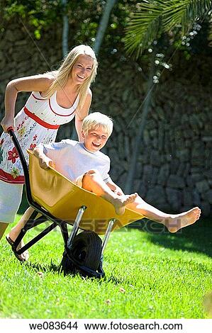 amusing, boy, barrow, barefoot, amusement View Large Photo Image Picture - amusing, boy, barrow, barefoot, amusement. Fotosearch