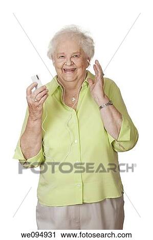 An elderly Caucasian woman listening to music on an mp3 player View Large Photo Image Stock Image - An elderly Caucasian woman listening to music on an mp3 player. Fotosearch