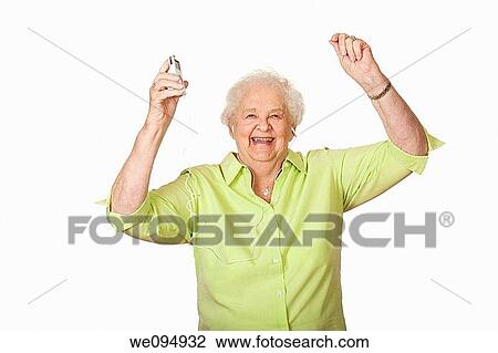 An elderly Caucasian woman listening to music on an mp3 player View Large Photo Image Stock Image - An elderly Caucasian woman listening to music on an mp3 player. Fotosearch