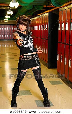 Angry young female heavy metal punk rocker pointing in a basement school locker room View Large Photo Image Stock Photograph - Angry young female heavy metal punk rocker pointing in a basement school locker room. Fotosearch