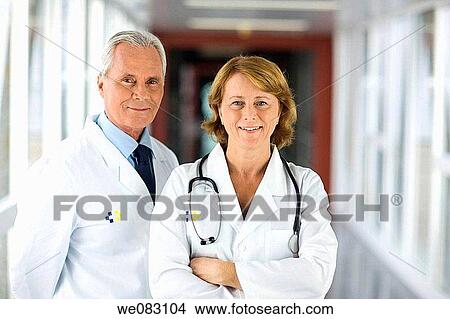 Picture - arms folded, colleague, baby boomer, Arms crossed. Fotosearch