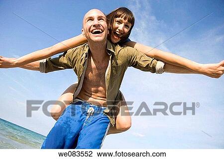 Arms open, carefree, beach, balance, amusement View Large Photo Image Stock Image - Arms open, carefree, beach, balance, amusement. Fotosearch