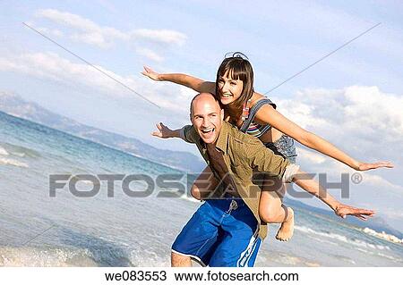 Arms open, carefree, beach, balance, amusement View Large Photo Image Stock Image - Arms open, carefree, beach, balance, amusement. Fotosearch