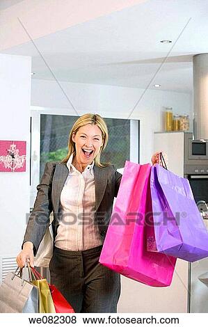 Arms raised, blond, bag, at-home, addiction View Large Photo Image Stock Photo - Arms raised, blond, bag, at-home, addiction. Fotosearch