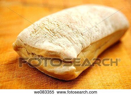 Stock Photography - Artisan bread, ciabatta, on a cutting board. Fotosearch