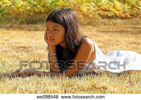 Asian young girl lying down beside a camping tent, France Landes Forest View Large Photo Image Stock Photo - Asian young girl lying down beside a camping tent, France Landes Forest. Fotosearch