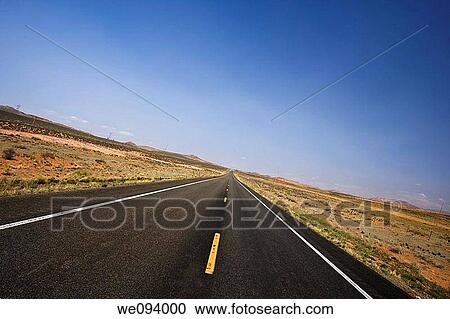 Asphalt highway running straight for miles to the horizon View Large Photo Image Stock Image - Asphalt highway running straight for miles to the horizon. Fotosearch
