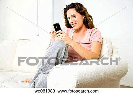 at-home, brown hair, barefoot, addiction View Large Photo Image Stock Image - at-home, brown hair, barefoot, addiction. Fotosearch