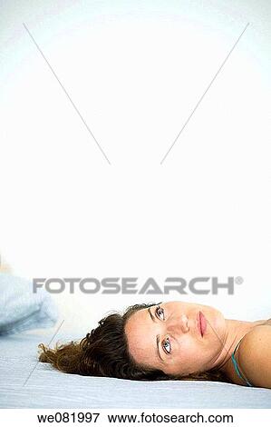 at-home, brown hair, blue eyes, bed, absorbed View Large Photo Image Stock Photo - at-home, brown hair, blue eyes, bed, absorbed. Fotosearch