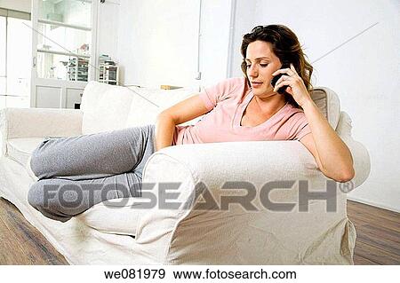 Stock Photo - at-home, calling, brown hair, apartment. Fotosearch