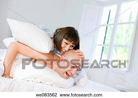 Stock Image - at-home, catch, bedroom, bed, amusement. Fotosearch