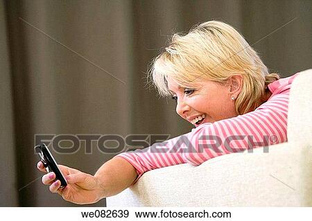 at-home, cell phone, blond, addiction View Large Photo Image Stock Photo - at-home, cell phone, blond, addiction. Fotosearch