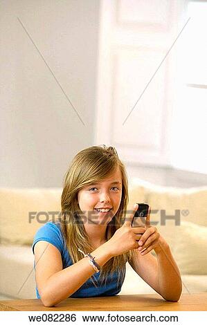 at-home, cell phone, brown hair, blue eyes, addiction View Large Photo Image Stock Photograph - at-home, cell phone, brown hair, blue eyes, addiction. Fotosearch