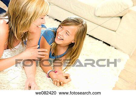 Stock Image - at-home, child, carpet, amusement. Fotosearch