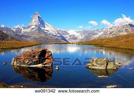 At lake Stellisee near Zermatt, Mt Matterhorn in the background, Zermatt, Valais Switzerland View Large Photo Image Stock Image - At lake Stellisee near Zermatt, Mt Matterhorn in the background, Zermatt, Valais Switzerland. Fotosearch