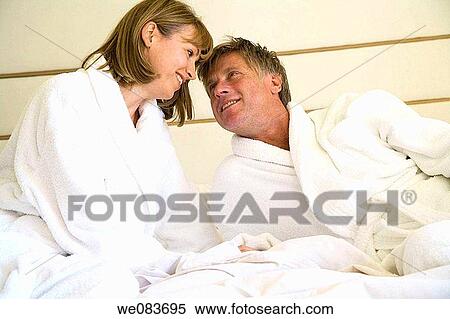Stock Photography - attraction, bed, bathrobe, baby boomer, affection. Fotosearch