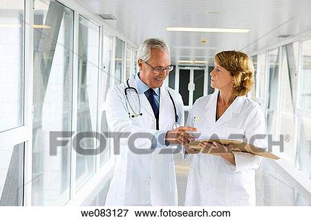Stock Photo - baby boomer, colleague, consult. Fotosearch