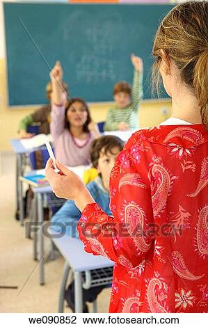 Stock Image - back view, boy, board, blackboard, Arm raised. Fotosearch