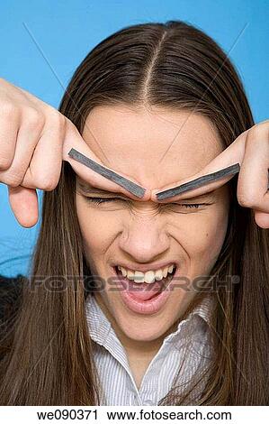 Stock Image - Bad mood, chestnut hair, brown hair, angry. Fotosearch