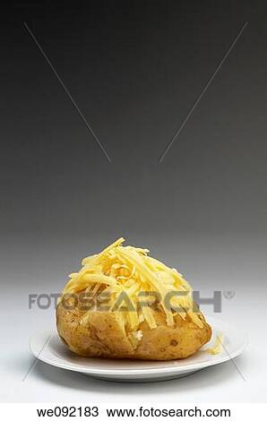 Baked potato with cheddar cheese View Large Photo Image Stock Image - Baked potato with cheddar cheese. Fotosearch