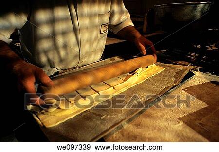 Baker s hands rolling up pastry in a french bakery View Large Photo Image Stock Photo - Baker s hands rolling up pastry in a french bakery. Fotosearch