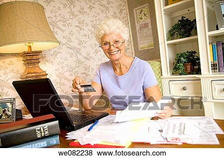 Stock Photo - Bank card, check, bill, at-home. Fotosearch