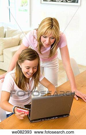 Stock Image - Bank card, child, at-home. Fotosearch