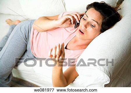 barefoot, cell phone, brown hair, at-home View Large Photo Image Stock Photo - barefoot, cell phone, brown hair, at-home. Fotosearch