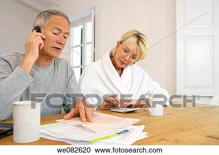 Stock Image - bathrobe, calling, calculator, bill, at-home. Fotosearch