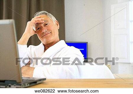 Stock Image - bathrobe, computer, at-home. Fotosearch