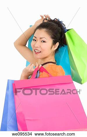Picture - Beautiful and sexy Asian woman carr shopping bags. Fotosearch