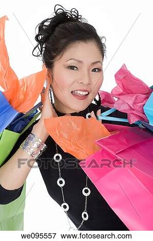 Beautiful and sexy Asian woman carrying shopping bags View Large Photo Image Stock Photo - Beautiful and sexy Asian woman carrying shopping bags. Fotosearch