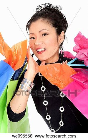 Beautiful and sexy Asian woman carrying shopping bags View Large Photo Image Stock Photo - Beautiful and sexy Asian woman carrying shopping bags. Fotosearch