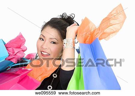 Beautiful and sexy Asian woman carrying shopping bags View Large Photo Image Stock Photo - Beautiful and sexy Asian woman carrying shopping bags. Fotosearch