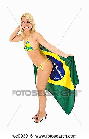 Beautiful and sexy caucasian woman in her early 20s posing in a Brazilian thong bikini and holding a Brazilian flag on a white background View Large Photo Image Stock Photograph - Beautiful and sexy caucasian woman in her early 20s posing in a Brazilian thong bikini and holding a Brazilian flag on a white background. Fotosearch