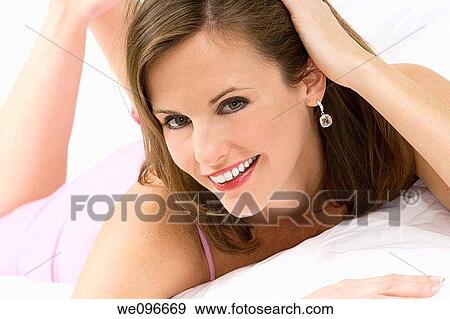 Beautiful and sexy Caucasian woman laying in bed View Large Photo Image Stock Photo - Beautiful and sexy Caucasian woman laying in bed. Fotosearch