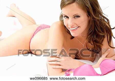Stock Photography - Beautiful and sexy Caucasian woman laying in bed. Fotosearch