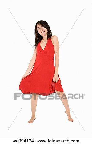 Beautiful Asain woman in a red sundress poing on a white background View Large Photo Image Picture - Beautiful Asain woman in a red sundress poing on a white background. Fotosearch