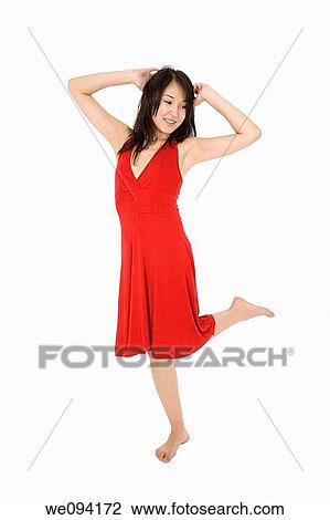 Beautiful Asain woman in a red sundress poing on a white background View Large Photo Image Stock Image - Beautiful Asain woman in a red sundress poing on a white background. Fotosearch