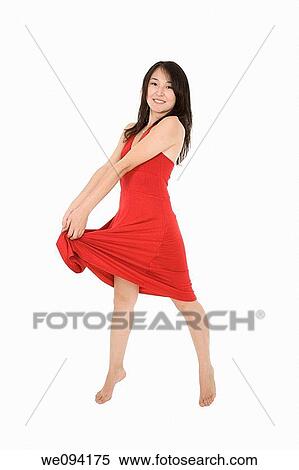Beautiful Asain woman in a red sundress posing on a white background View Large Photo Image Stock Photography - Beautiful Asain woman in a red sundress posing on a white background. Fotosearch