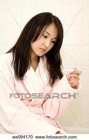 Beautiful Asain woman unhappy she tested positive for pregnancy View Large Photo Image Stock Image - Beautiful Asain woman unhappy she tested positive for pregnancy. Fotosearch