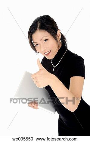 Beautiful Asian businesswoman giving the thumbs up or the ok sign View Large Photo Image Stock Image - Beautiful Asian businesswoman giving the thumbs up or the ok sign. Fotosearch