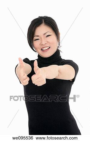 Beautiful Asian businesswoman giving the thumbs up or the ok sign View Large Photo Image Stock Photograph - Beautiful Asian businesswoman giving the thumbs up or the ok sign. Fotosearch