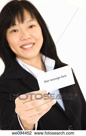 Beautiful Asian businesswoman holding a business card View Large Photo Image Stock Image - Beautiful Asian businesswoman holding a business card. Fotosearch