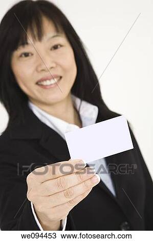 Beautiful Asian businesswoman holding a business card View Large Photo Image Stock Image - Beautiful Asian businesswoman holding a business card. Fotosearch