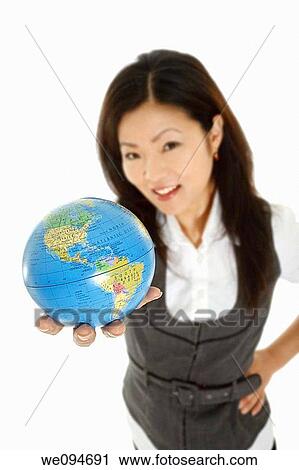 Beautiful Asian businesswoman with the world in the palm of her hand View Large Photo Image Stock Image - Beautiful Asian businesswoman with the world in the palm of her hand. Fotosearch